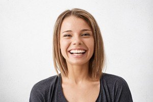 girl in grey shirt laughing