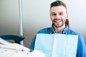 man smiling with smock on