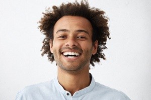 man with curly hair looking at camera