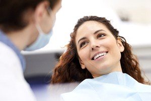 woman with long hair laying back in exam chair