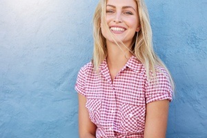 woman in checkered shirt smiling