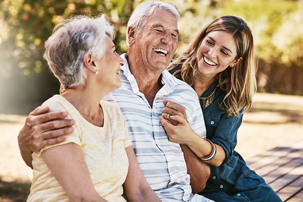 Senior man laughing with his wife and daughter