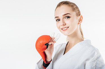 woman holding a mouthguard