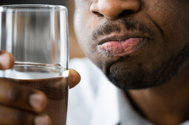 a man rinsing his mouth with saltwater