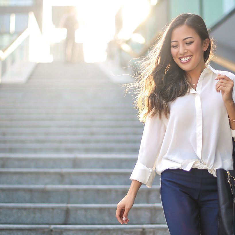 woman smiling walking outside