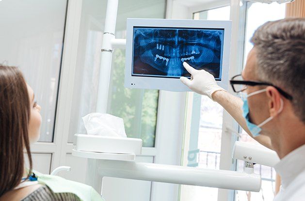 dentist showing patient x-rays