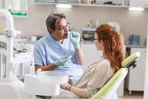 A patient talking with her cosmetic dentist
