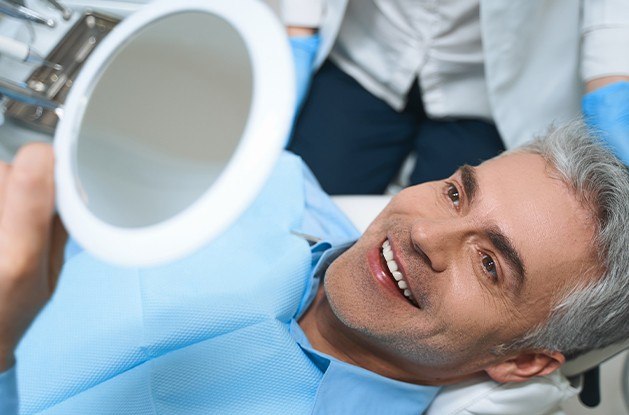 man looking at smile in circle mirror