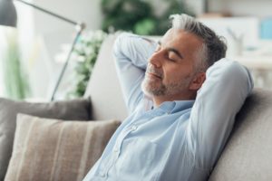 man relaxing after dental implant surgery in East Longmeadow and Northampton