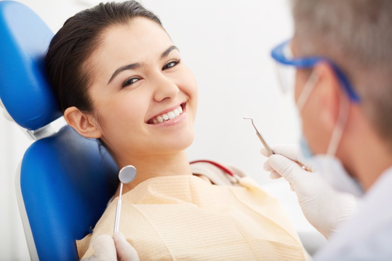 woman receiving early detection of oral health problems
