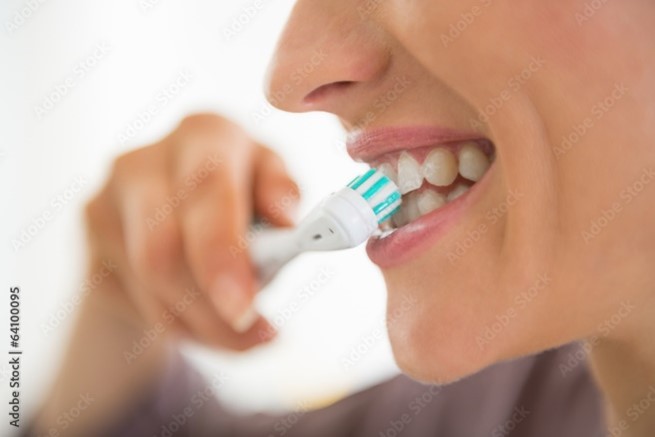 Woman brushing her teeth.