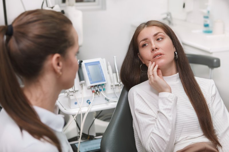 A woman seeing a dentist for a common dental emergency