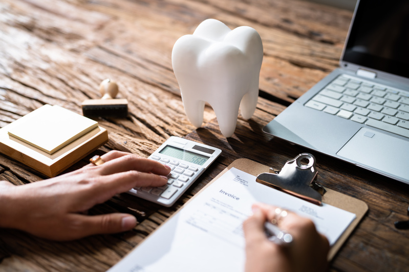 A patient working on a dental insurance form