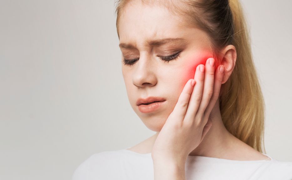 A woman with a painful tooth infection