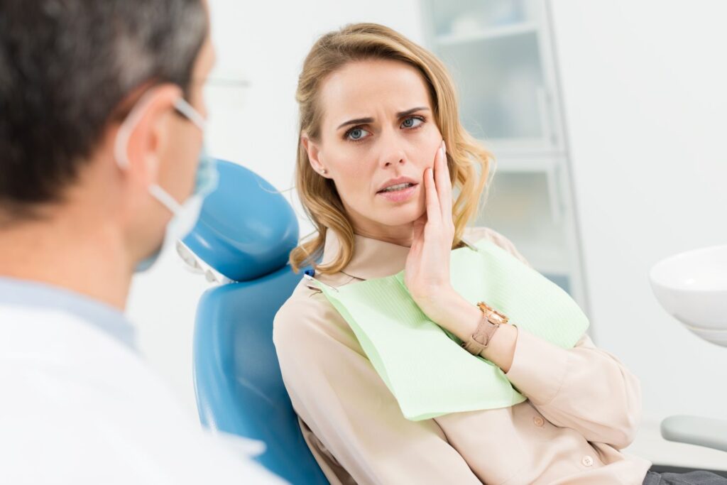 A woman with a painful toothache at the dentist’s office