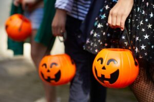 Kids holding trick-or-treat buckets.