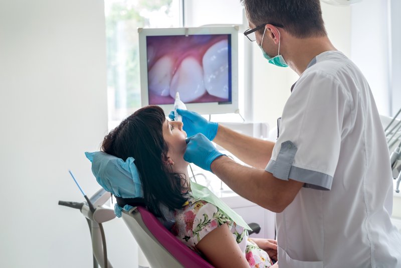 Dentist checking patients' teeth to see if they need a dental crown
