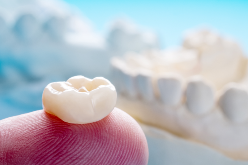 Dental crown on fingertip